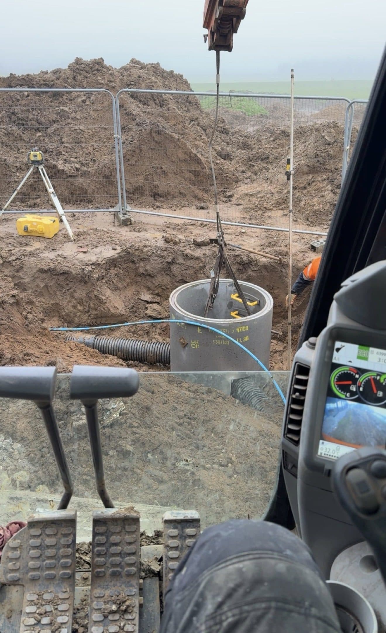 Precast concrete manhole ring being lifted into an excavation on a drainage job at Boroughbridge