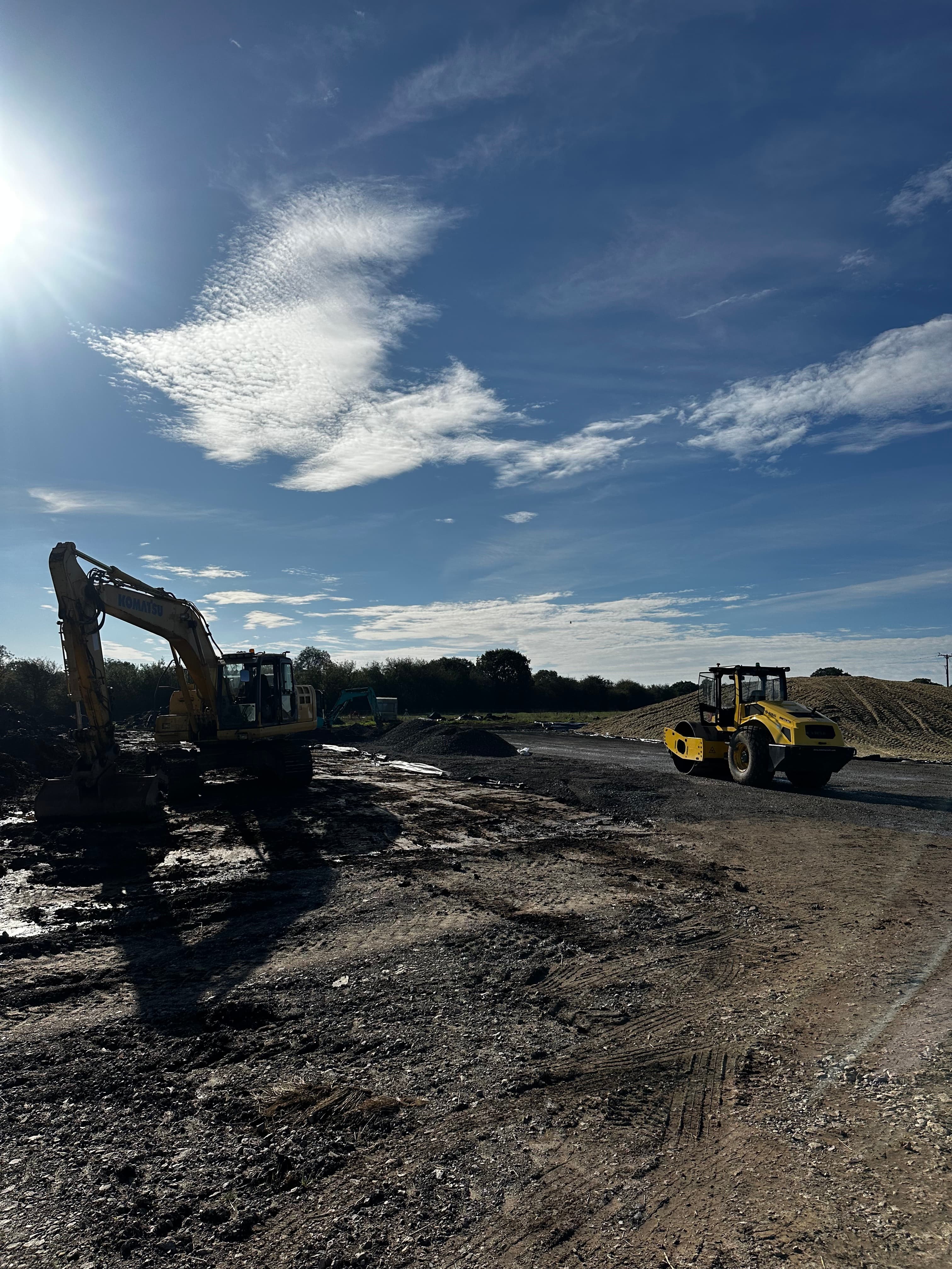 Excavator and roller on an earthworks site